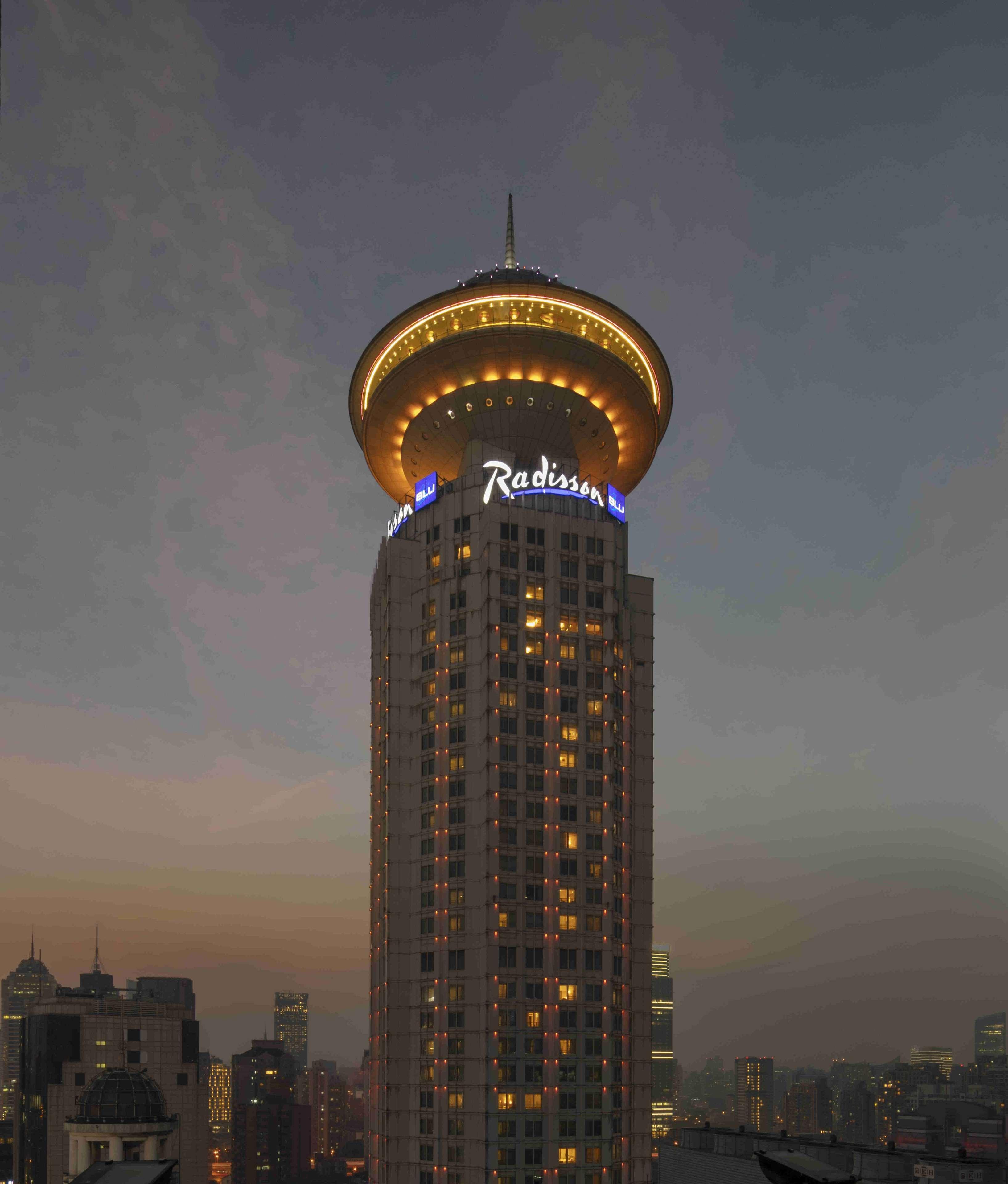 Radisson Blu Hotel Shanghai New World Exterior photo The hotel at night
